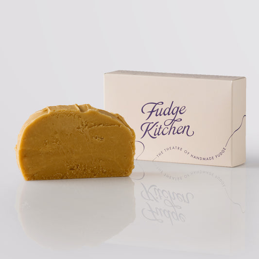 Sea Salted Caramel Fudge single slice, a Fudge Kitchen indulgent, handmade fudge flavour displayed with an elegant gift box.